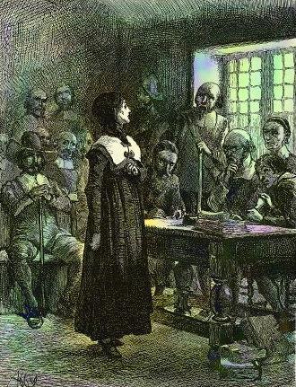 In a small colonial room with light coming through a window, a brave-looking woman in Puritan dress stands in front of a desk where a judge listens thoughtfully to her, his fist at his mouth. A number of men, also Puritans, sits around the room, observing. artist: Edwin Austin Abbey, 1901. Retrieved from Wikimedia Commons. Public domain. 
